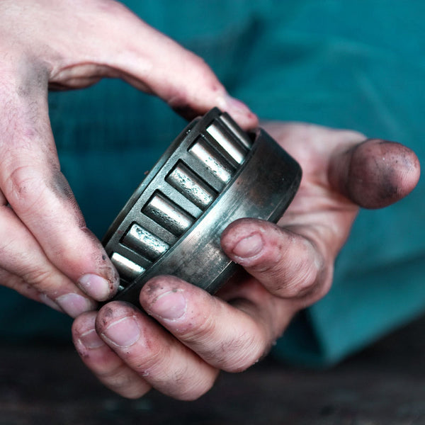 hands holding a gear